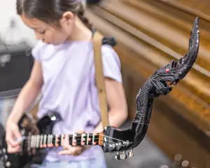 girl playing a Phin instrument from Thailand at Backbeat Music Academy